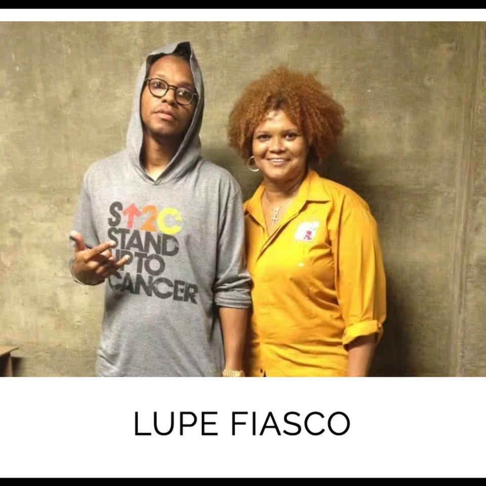 Lupe Fiasco in a grey hoodie next to a woman with curly hair in a yellow shirt.