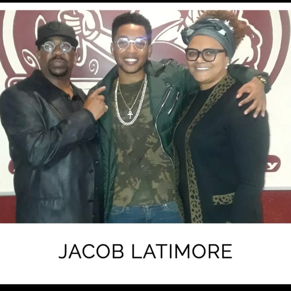 Jacob Latimore with a man and woman, smiling at Kountry Kitchen soul food restaurant.