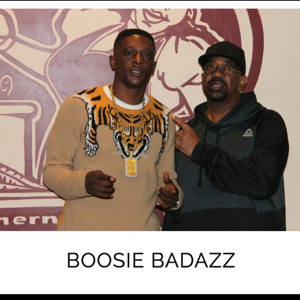 Boosie Badazz in a tiger-print sweater with a man in a black hoodie at Kountry Kitchen.