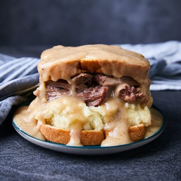 Kountry Kitchen's hot roast beef sandwich with mashed potatoes and gravy on a plate.