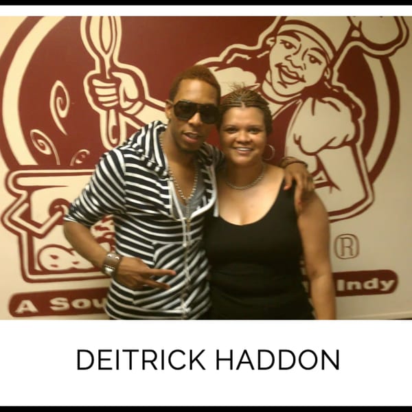 Deitrick Haddon and a woman smiling in front of Kountry Kitchen's chef logo.