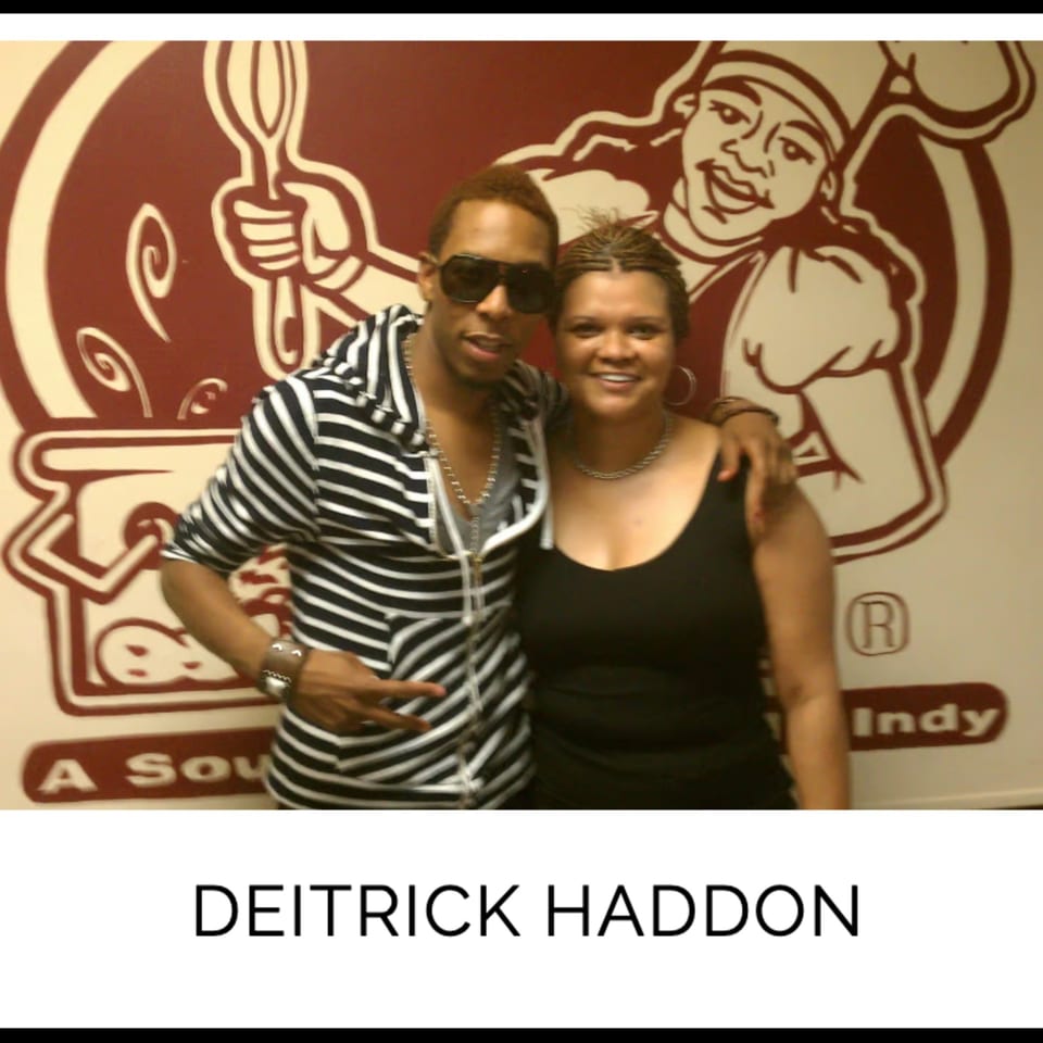 Deitrick Haddon and a woman smiling in front of Kountry Kitchen's chef logo.