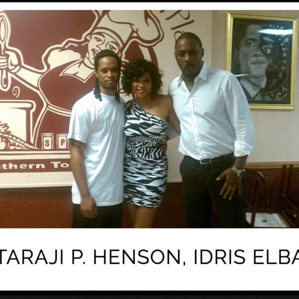Taraji P. Henson and Idris Elba posing with a man in front of a Kountry Kitchen mural.